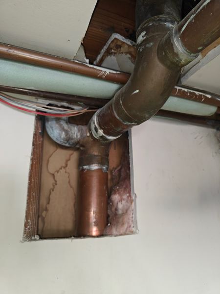 Copper and cast-iron pipe repair through an opened ceiling