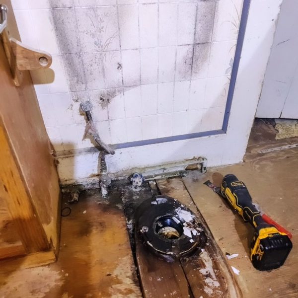 Tub drain repair through an opened floor
