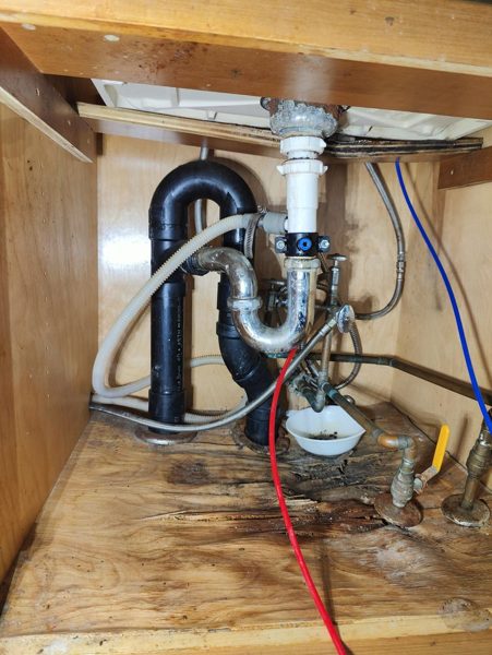 New sink drain trap and supply lines under a vanity