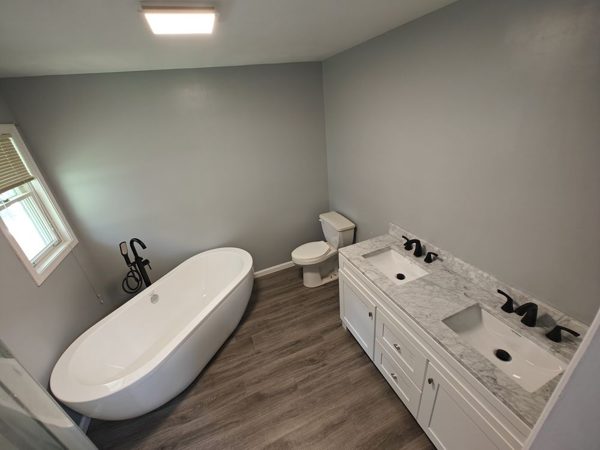 Finished bathroom with freestanding tub and double vanity