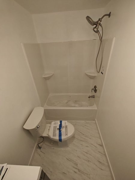 New tub and shower surround with toilet